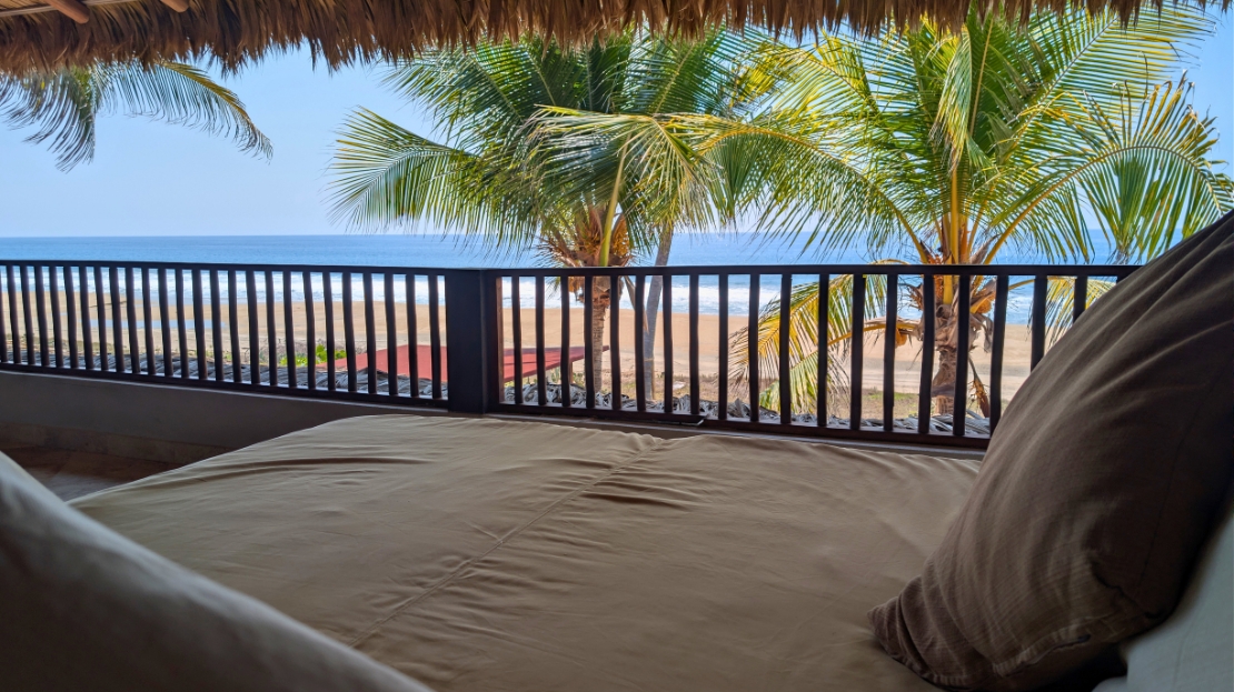 Balcony daybed with ocean and palm view